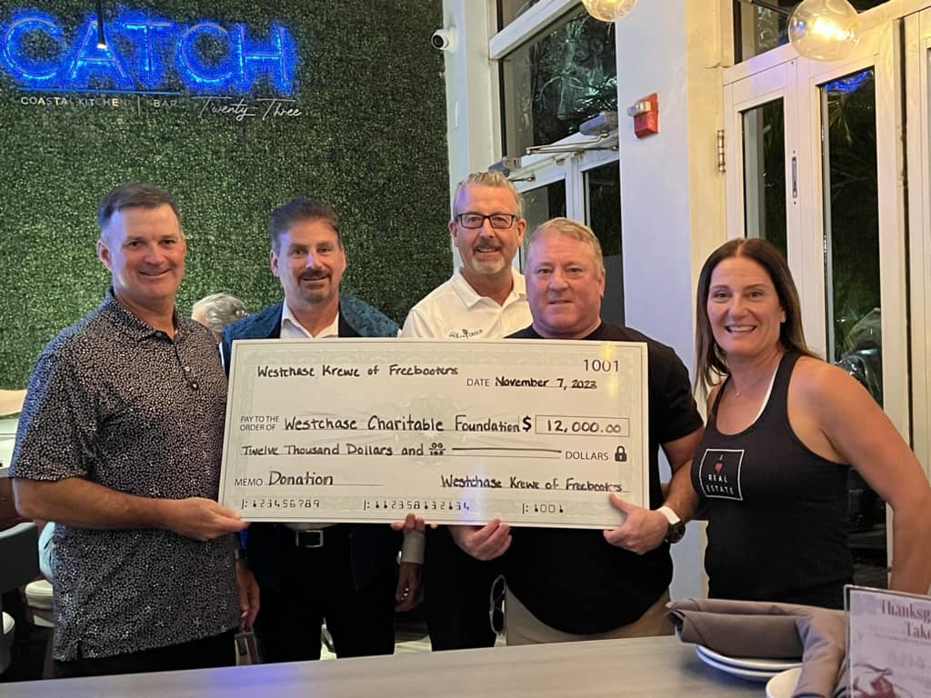 Freebooters Krewe presenting donation check to WCF